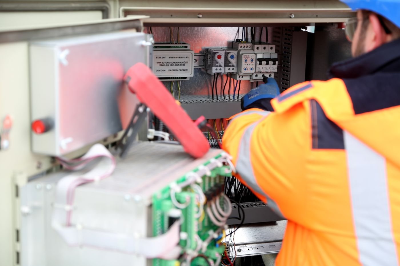 Technician wiring an electrical transfer switch enclosure
