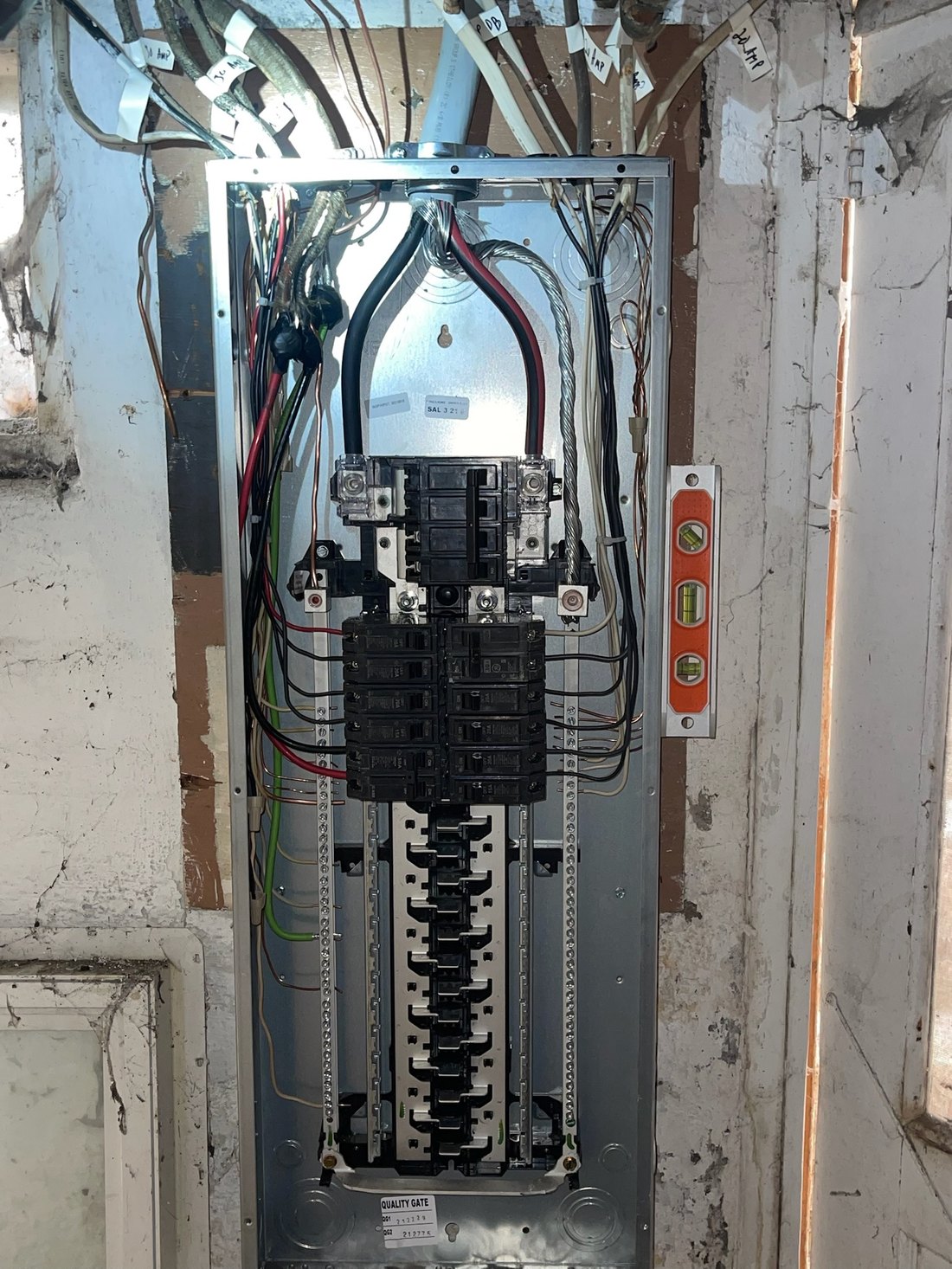 A newly installed 200-amp residential load center with conductors dressed and every circuit labelled